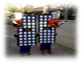 A group of people on a sidewalk
Description generated with high confidence
