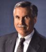 A person wearing a suit and tie

Description automatically generated