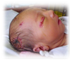 A picture containing indoor, person, baby
Description generated with very high confidence