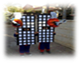 A group of people on a sidewalk

Description generated with high confidence