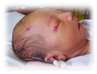 A picture containing indoor, person, baby
Description generated with very high confidence